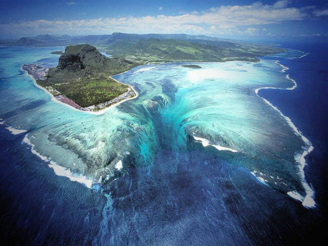 Thác dưới nước, Mauritius: Khi nhìn từ trên cao, đảo Mauritius ở Ấn Độ Dương dường như nằm gần thác dưới nước. Nhưng hiện tượng tuyệt đẹp này thực chất chỉ là ảo giác được tạo ra bởi dòng nước chảy giữa ụ cát.
