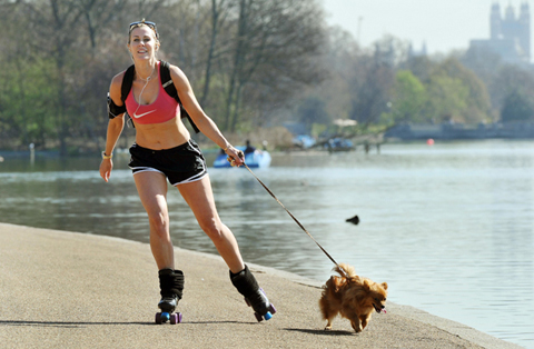 Sunniest March since 1929. File photo dated 28/3/2012 of Alex Hamilton, aged 33, from Notting Hill roller skates with her dog Tinkerbell beside the Serpentine in Hyde Park central London as the warm weather continues across the UK. March was the sunniest month since 1929, and the warmest since 1997 according to forecasters. Issue date: Monday April 2, 2012. The highest maximum temperature recorded was 23.6 degrees in Aboyne, Aberdeenshire, on March 27 which was a new Scottish record for March. See PA story WEATHER Sun. Photo credit should read: John Stillwell/PA Wire URN:13209020 (Press Association via AP Images)